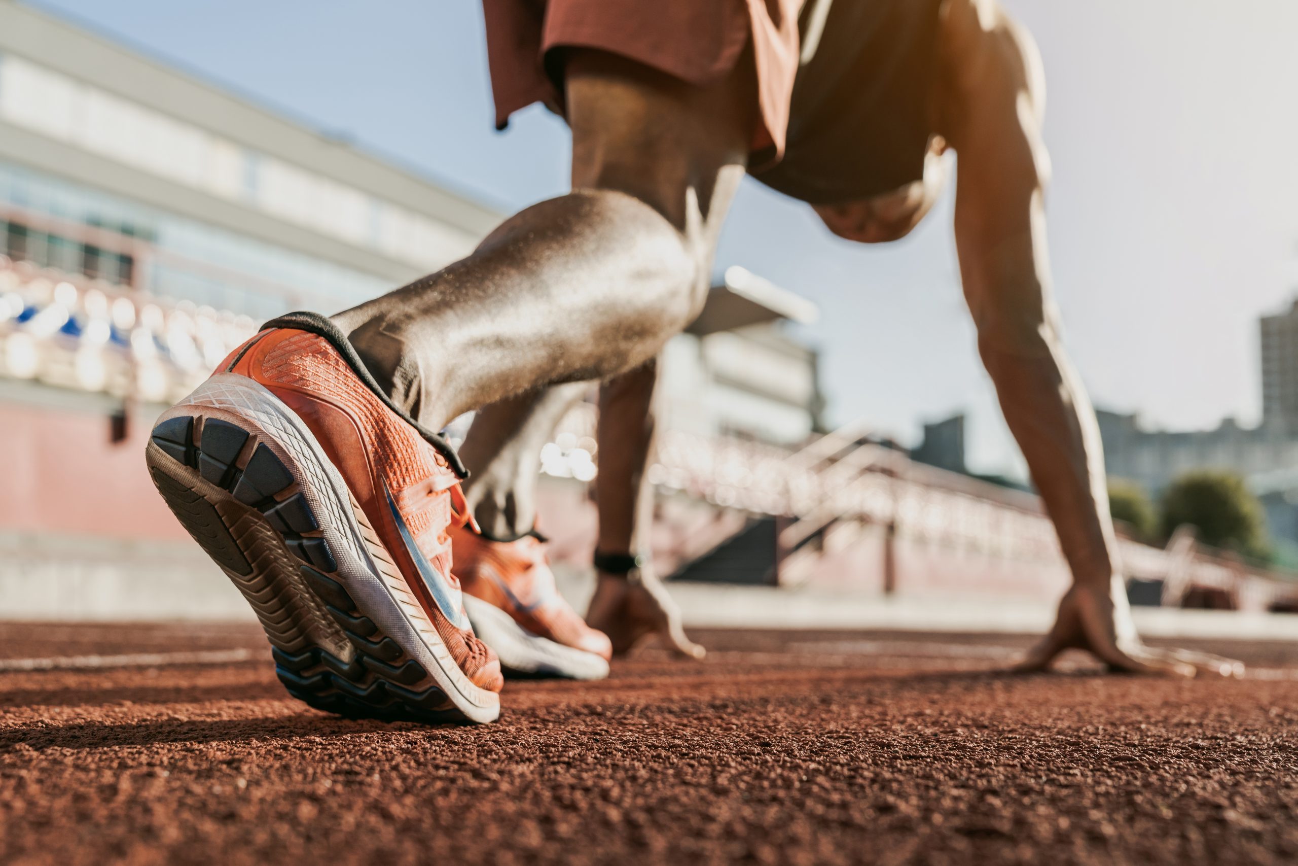 Male athlete preparing to run on track representing sports chiropractic care
