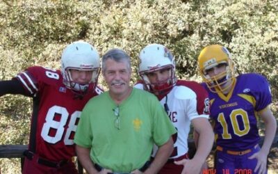 Father and sons playing football representing concussion awareness by Dr. Derek Larsen chiropractor in Juneau Alaska
