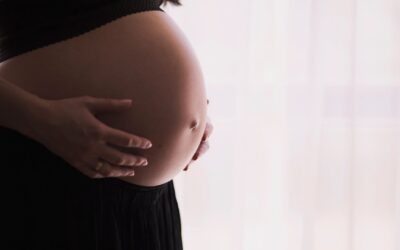 Expecting mother relaxing comfortably on a supportive massage table during a prenatal massage session